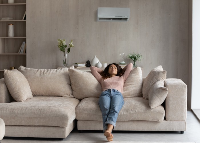 Women relaxes in living room with air conditioning